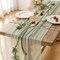 120-inch (10 ft) green cheesecloth table runner, perfect for adding a rustic boho touch to weddings, baby showers, bridal showers, or home décor. This sheer gauze runner serves as an elegant centerpiece, ideal for creating a soft, textured look on an